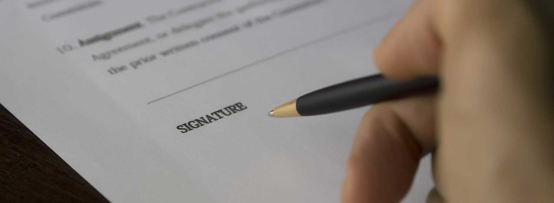 picture of a person signing an agreement